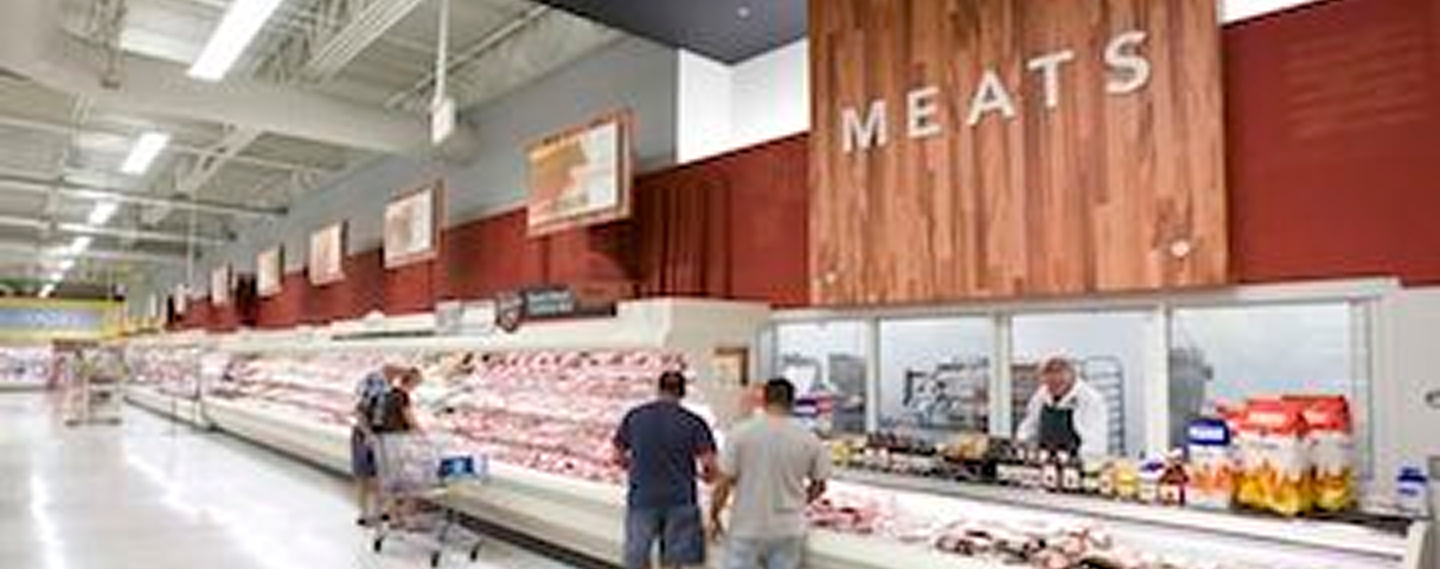 Fresh vegetables including tomatoes, cucumbers, and bell peppers on a wooden table