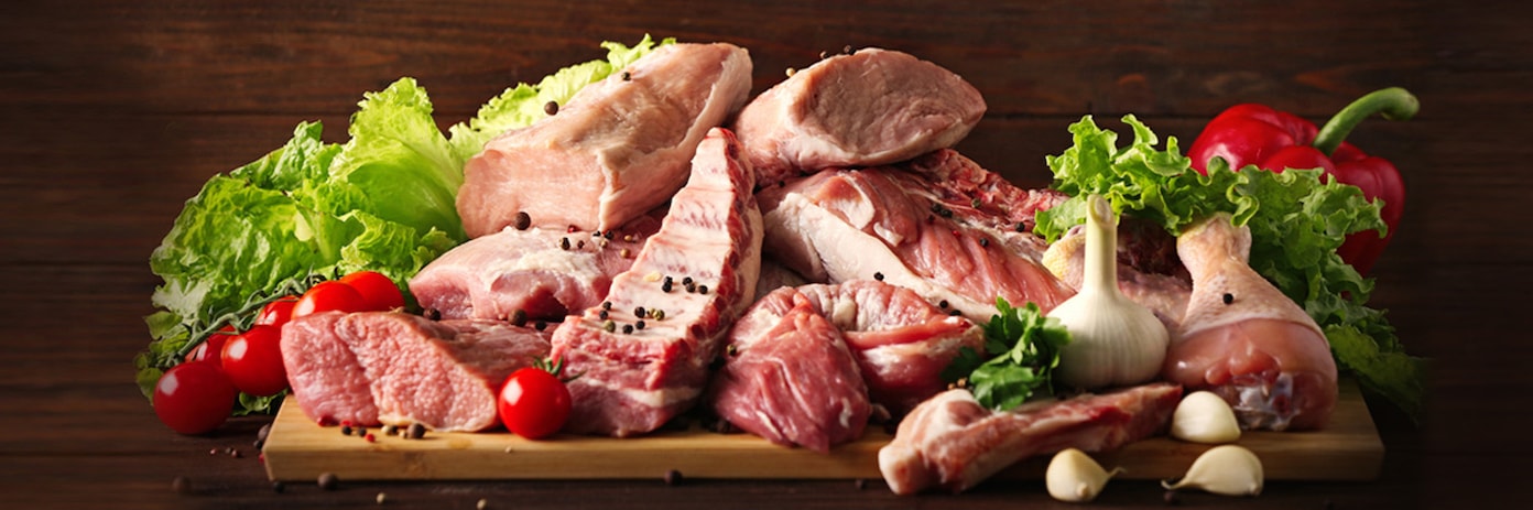 Interior of a Meat market with wooden tables, chairs, hanging lights, and shelves with meat products